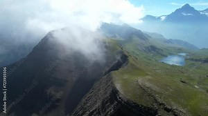 Grindelwald Bernese Alps mountain range in the clouds Switzerland aerial drone full hd 4k panoramic landscape Stock Video