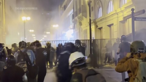 Tear gas fired as police crack down on young demonstrators marching in Peru capital