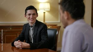 A structured discussion between two individuals in an office, focusing on their collaborative goals and strategies