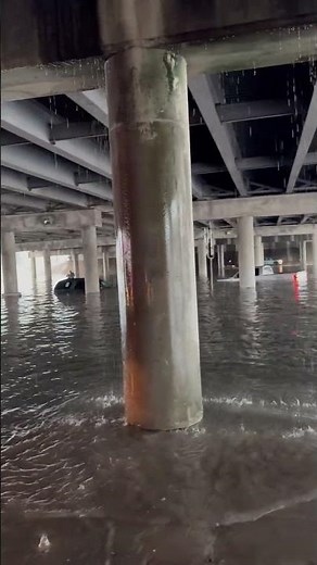 Flash Flood Inundates City Street and Submerges Vehicles Under Overpass