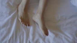 feet relaxation on the comfortable bed.