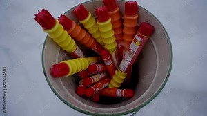 Full metal bucket with Maritime Distress signals standing on snowy ships deck, handheld Stock Video