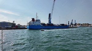 Poole Dorset England UK. 26.08.2025. Port of Poole southern England with Trinity a general cargo vessel alongs the terminal.
