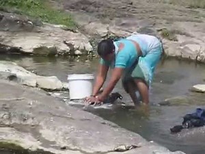EK NAZAR - A LADY WASHING CLOTHES NEAR RIVER SIDE AT SINNAR, NASHIK, MAHARASHTRA, INDIA