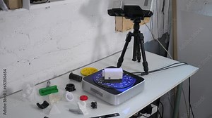 Close-up of a working modern 3D scanner reading data from a plastic object. A 3D scanner scans a plastic model in a modern laboratory. The process of creating 3D models.