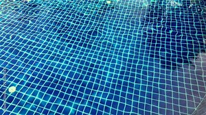 Ripple Water in swimming pool with sun reflection. Summer day at swimming pool.