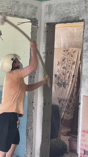 Hammering concrete wall with sledgehammer Breaking cement wall manually Sledgehammer demolition work