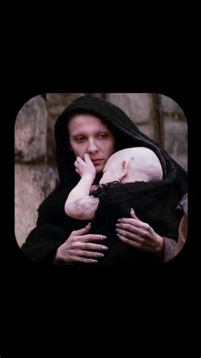 Royal Cinema on Instagram: "The Passion of the Christ is a visceral and intensely emotional cinematic portrayal of the final hours of Jesus' life. Among its most haunting and symbolic moments is the scene during the brutal scourging of Jesus, where the figure of Satan is seen walking through the crowd carrying a grotesque baby. The baby, initially appearing innocent from behind while cradled in the androgynous figure's arms, turns its head to reveal a sinister, demonic face with aged features, g