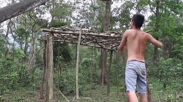 Building primitive mud houses with grass growing around