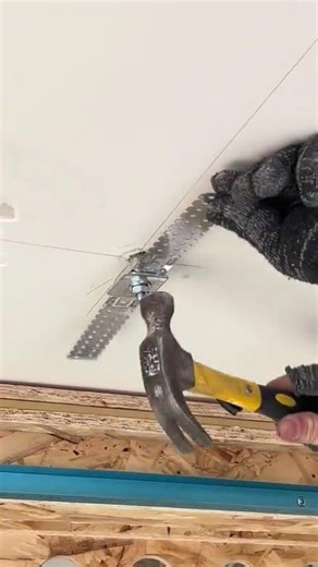 someone is installing a ceiling mount or bracket component