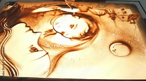 Drawing with sand. Drawing sand on a white screen. Sand Artist. Hands draws