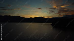 morning sunrise in lake atitlan guatemala in a timelapse showing much movement and fishing in foreground with mountains in background south america