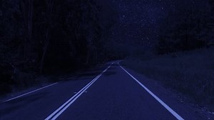 Rear facing night driving point of view POV for interior car scene green screen replacement - night footage under a clear starry sky, on quiet deserted outback roads, with brooding trees either side