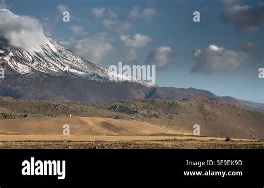 Snowy Mount Hasan volcano rises above Central Anatolia plains in Turkey under clear sky. High altitude volcanic cone creates dramatic landscape with icy slopes, clouds, and vast steppe. mountain, ridge, summit, rocky Stock Video Footage - Alamy