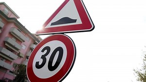 Restrictive road signs against modern apartment building