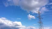 4K aerial footage of high voltage power lines and tall electricity...