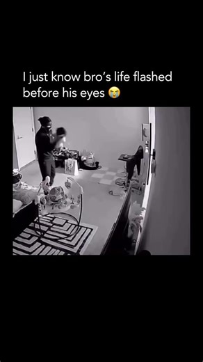Funniest Memes Ever on Instagram: "Just in time 😭💀 This clip captures a “dad reflex” moment caught on a home security camera. A father is seen playfully tossing his toddler into the air—a common way parents play with their kids—but things take a terrifying turn when he loses his grip. The child begins to fall backward, heading straight toward the floor, while a woman (presumably the mother) can be seen relaxing in the background, unaware of the immediate danger. In a split-second display of pu