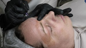 meticulous process of eyebrow tattooing, showcasing a skilled artist's fine work. Watch how deft strokes fill out thinning brows, resulting in a naturally enhanced appearance. eyebrow tattooing.