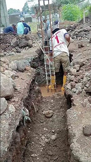 Traditional Construction Methods: manual stone foundation excavation.