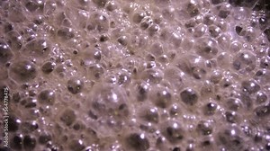 Gray foam with bubbles from the boiling of a thick sticky liquid. A nasty substance. Stock Video