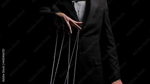 Puppeteer pulls the doll strings tied to his fingers. Puppet rope manipulation concept and control hand. Businessman controls the mind and actions of people. Close up. Slow motion.