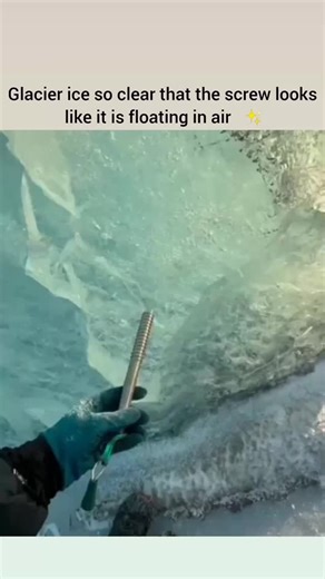 Daily Dose BD on Instagram: "Deep within the frozen landscapes of a remote glacier, a rare phenomenon of optical transparency is captured as an ice screw is driven into a wall of solid ice. This extraordinary clarity is the result of centuries of glacial pressure, which eliminates internal fractures and air pockets, allowing the ice to behave like a giant lens. As the climber rotates the screw, the metal appears to be suspended in a void, creating a mesmerizing visual that blurs the line between