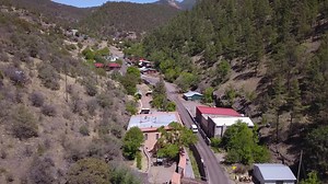 Due to the isolation and the rugged terrain surrounding the community, Mogollon had a reputation as one of the wildest mining towns in the West. There was little in the way of law enforcement. Gamblers, miners and robbers considered the community a sanctuary. There were five saloons, two restaurants, four mercantiles, two hotels, and numerous brothels located in two infamous red light districts. The town had a photographer, the Midway Theatre, an ice maker, and a bakery. There was daily stage se