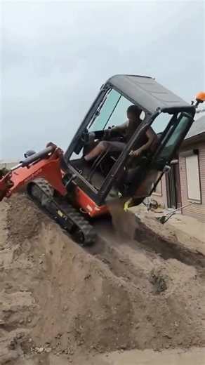 homeowner was using a small backhoe on a steep hill when it suddenly tipped during a rotation.