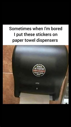 Johnny Bravo Explains Memes on Instagram: "Hey everyone, Johnny here to explain. This meme shows a public restroom paper towel dispenser with a sticker that says: “VOICE ACTIVATED — SAY LOUDLY ‘PAPER TOWEL NOW!’” The caption above the image reveals that the person posting this likes to put these prank stickers on dispensers when they’re bored. The humor comes from imagining unsuspecting strangers actually yelling “Paper towel now!” into a completely normal, non-voice-activated dispenser, probabl