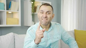 Mentally challenged man shouting at camera.