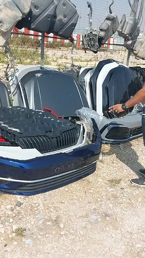 Exploring Damaged Car Parts in a Junkyard Setting