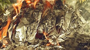 Diary, books and secret documents, letters set on fire. Burnt papers.