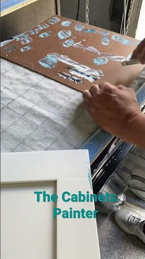 Patching cracks, dents, and scratches on the doors for cabinet refinishing.