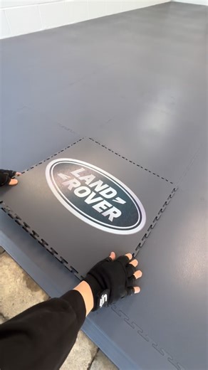Garage Style - Garage Flooring & Hexagon Lighting on Instagram: "Add a custom logo to your new garage floor for a touch of personalisation 🔨😎 This install used our graphite grey premium smooth pvc interlocking tiles 🏁"