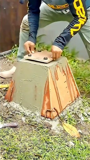 Rebar is manually inserted into the base of the concrete pillar