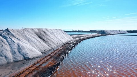 clip-4005382117-large-white-salt-heaps-along-narrow-railway