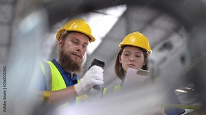 Workers Scanning machine steel parts. operation workers checking and inspecting cargo for stack items for shipping. Supervisor and staff working in factory warehouse discuss about parts inventory.