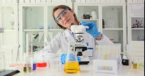 Food technologist studies food oils in laboratory. Testing of petroleum products in the laboratory