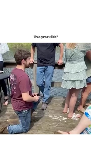 universal_education on Instagram: "- The post shares a 27-second video clip of a man proposing marriage on a lakeside dock surrounded by friends and family, where the woman's unenthusiastic response—looking away and minimal engagement—creates palpable awkwardness, overlaid with a meme reaction questioning if someone should inform him of her disinterest. - Posted by meme account @alphafox on 3 January 2026, it amassed over 10 million views in two days, tapping into viral trends of public proposal