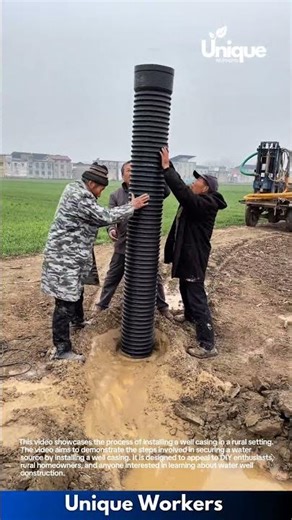 Deep Borewell Installation: Workers Lower Massive Pipe into Muddy Ground