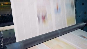 Special rollers rotate to move paper at a print office. 4K.