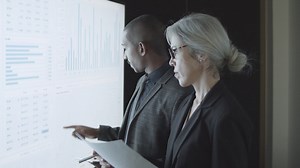 Free stock video - Finance broker explaining stock market statistics to investor