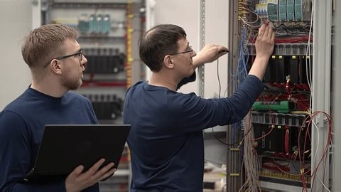 clip-3970080211-two-engineers-production-testing-electrical-equipment ...