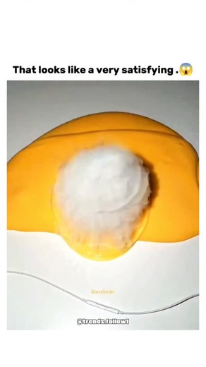 Films | Movies | Tv series on Instagram: "This X post features a 61-second video demonstrating the creation of a "slime egg" using orange slime as the yolk, a clear bubble for the white, and dry ice for a foggy sublimation effect, mimicking a sunny-side-up fried egg through playful manipulation. The dry ice reaction involves solid carbon dioxide rapidly turning to gas upon exposure to the slime's moisture, producing visible vapour without melting, a process explained in basic chemistry resources