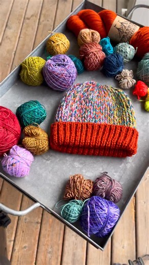 Wool & Pine on Instagram: "Okay, stashbusters. This one’s for you. 🧶 Bindle Hat takes all those fingering-weight scraps you’ve been saving and turns them into a marled, textural fabric that feels amazing on the needles. Eight strands held together, simple Latvian braids, and a whole lot of personality. It’s cozy, fast, and tbh kinda addictive. Watch the tutorial, grab your scraps, and cast on. Bindle and all hat patterns are 30% off through Monday. woolandpine.com + ravelry #stashbusting #yarnl