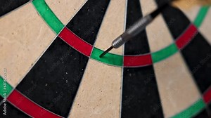 Dart arrow hitting in the target center of dartboard. Triple 19. 4K.