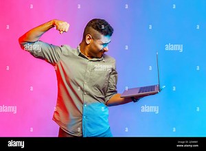 Angry man in shirt punching laptop screen, looking with furious mad expression, boxing threatening to hit while having video call. Indoor studio shot isolated on colorful neon light background Stock Photo - Alamy
