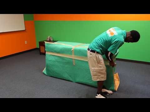 Wrapping a Dresser at College Hunks Hauling Junk & Moving
