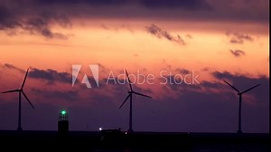 Copenhagen, Denmark Wind turbines at dawn spin over the Öresund straits.