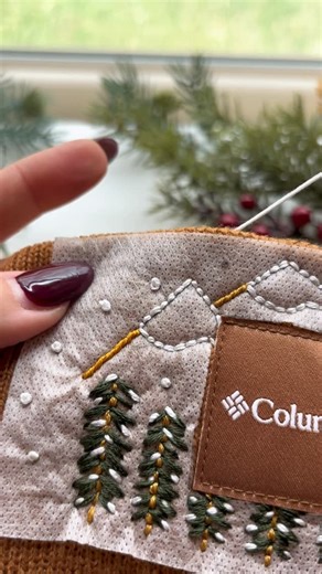 Stitchin With Samantha on Instagram: "Laundry? Nah. Starting on year end taxes early? Never. Another embroidery project? Done.😍✨ Consider this your sign to hand embroider your old beanie lying around in your house. This is such a fun winter DIY craft. ❄️🪡 ✨Stitching Information✨ - All 6 Strands of Thread - DMC Colors: BLANC, 935, 783, 729 - Mountain: Whipped Back Stitch Base, Back Stitch Snow Caps - Trees: Back Stitch Trunk, Straight Stitch Branches, Straight Stitch Snow - Snowflakes: French K